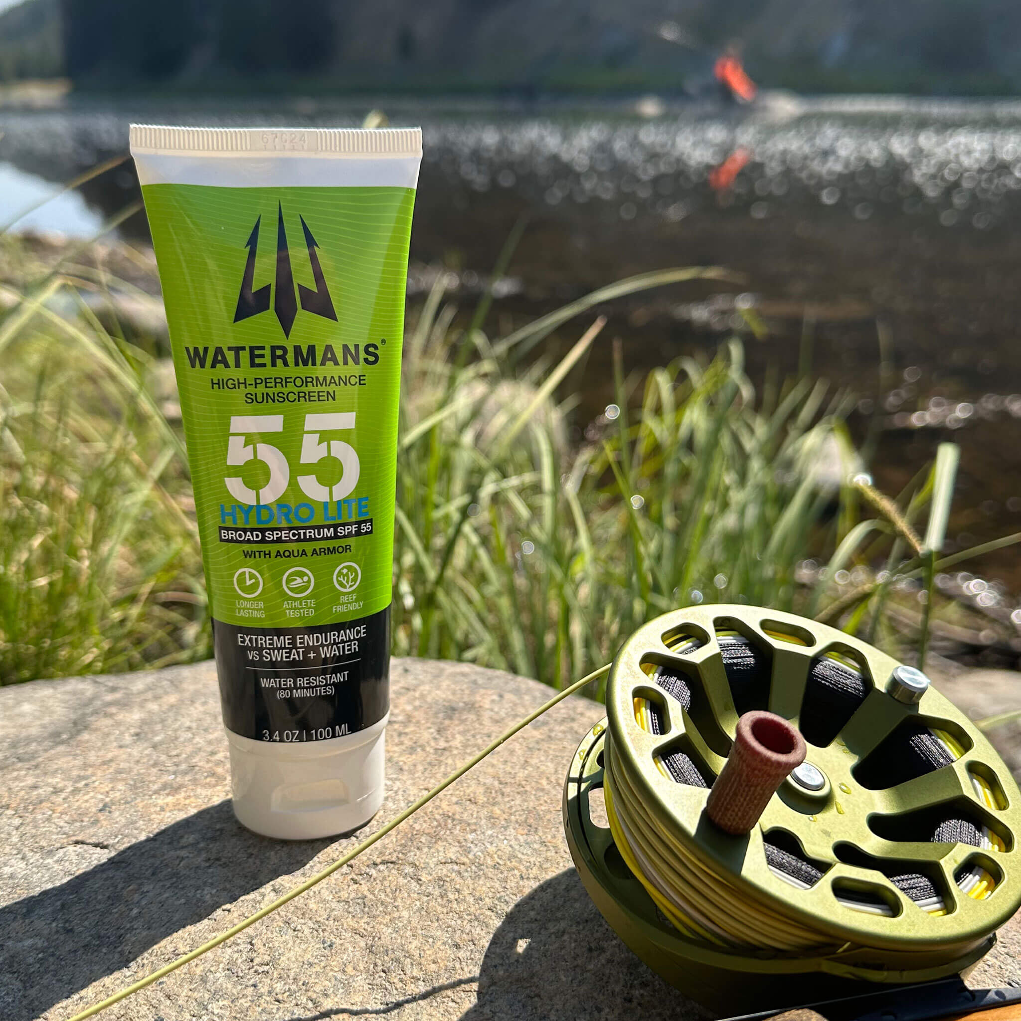 Watermans Hydro Lite SPF 55 sunscreen tube held outdoors in natural light