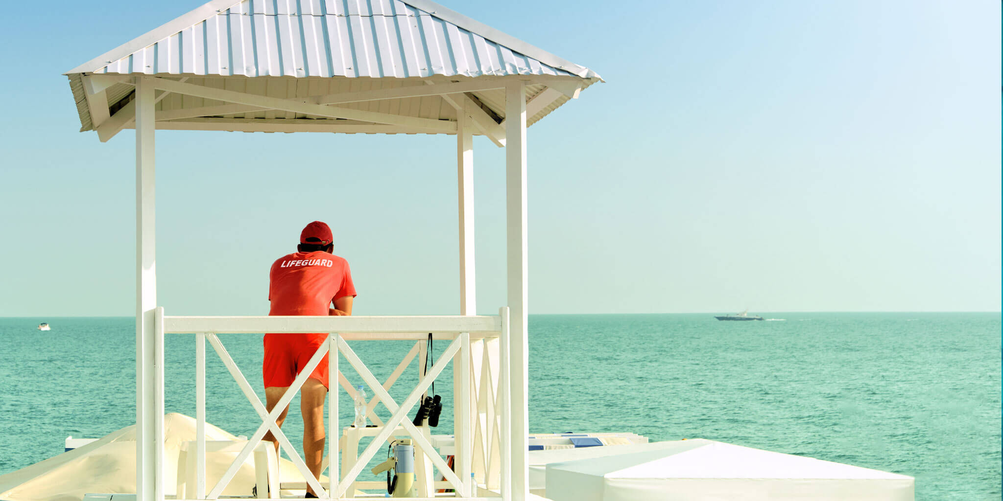 Lifeguard on a beach stand with a mineral sunscreen stripe across the nose