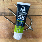 Athlete applying Watermans Mineral SPF 55 sunscreen before outdoor activity