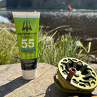 Watermans Hydro Lite SPF 55 sunscreen tube held outdoors in natural light